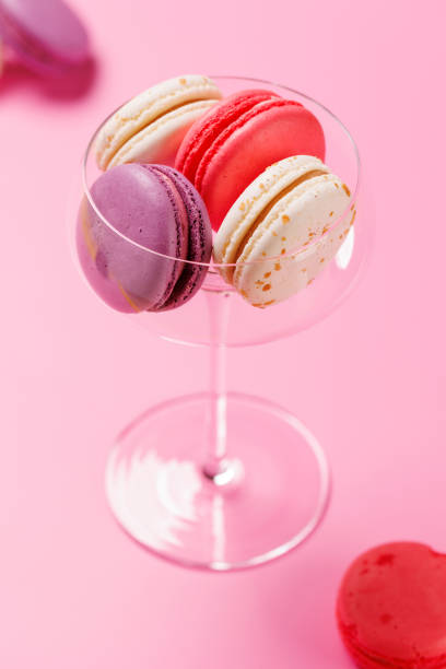 istock A delightful assortment of colorful macaroons arranged on a vibrant pink background 2201748961