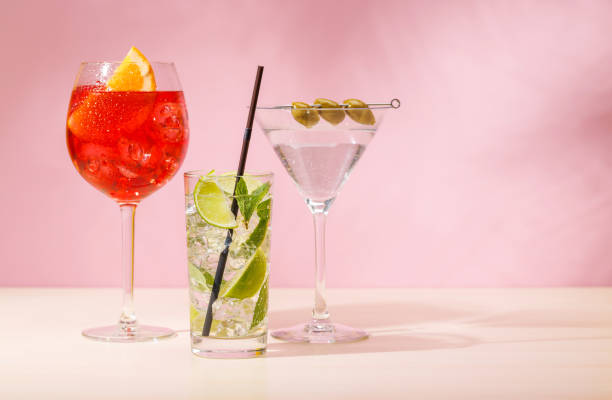 istock A variety of cocktails arranged on a table against a light pink background 2201749145