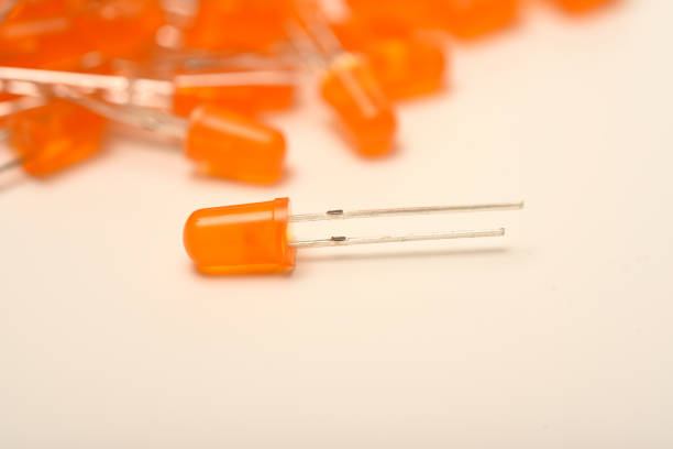 An orange LED on the background of a bunch of LED elements. One electronic LED.