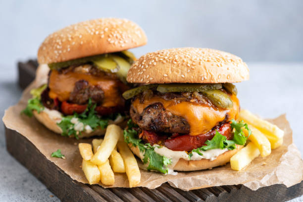 istock Two cheeseburgers and french fries 2201751895
