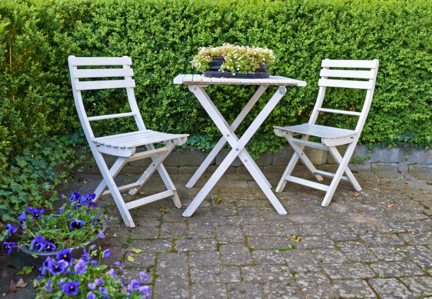 istock Cozy outdoor seating area with two white chairs and a table surrounded by greenery in a Spanish-style garden in Majorca 2201752748