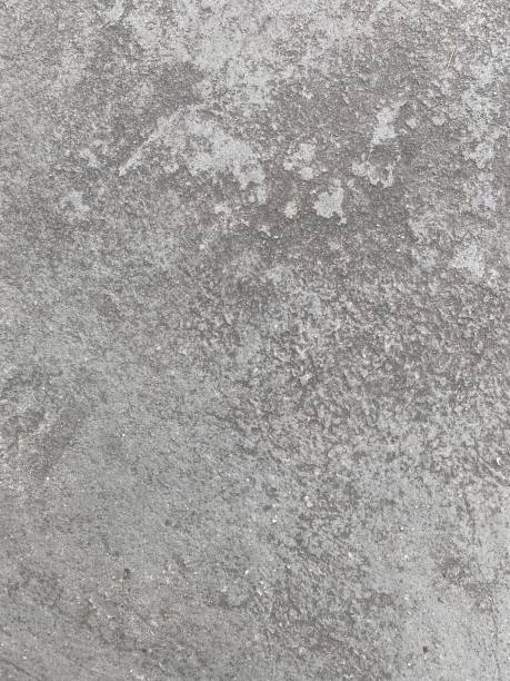istock Dusty concrete texture featuring a rugged cement surface with natural imperfections and subtle cracks. The aged, dusty finish offers an industrial vibe, perfect for minimalist designs. Floor texture. Wall background 2201757893