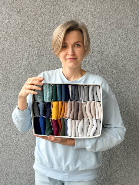 Woman holding an organizer with neatly folded colorful socks