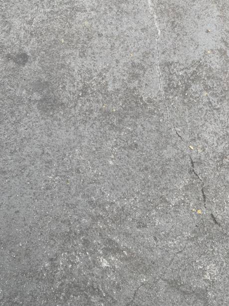 istock Dusty concrete texture featuring a rugged cement surface with natural imperfections and subtle cracks. The aged, dusty finish offers an industrial vibe, perfect for minimalist designs. Floor texture. Wall background 2201759080