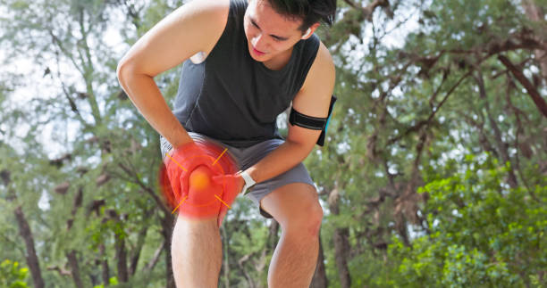 istock asian man running knee pain 2201759676