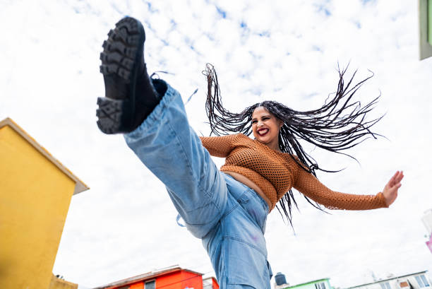 istock Young woman dancing outdoors 2201760451