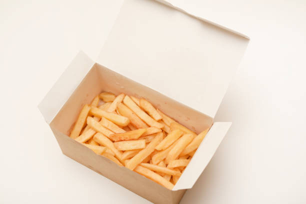 French fries on a cardboard box. Fried potatoes in a package.