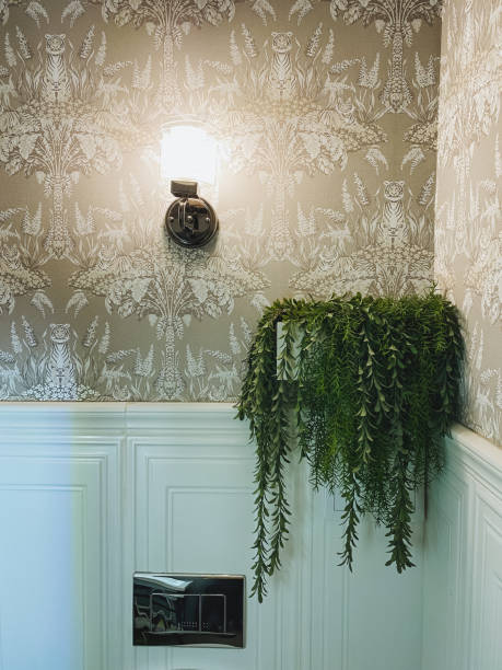 istock The bathroom features a beautiful plant elegantly hanging from the wall, accompanied by a stylish light fixture settled on the wall, creating a refreshing and inviting atmosphere 2201761083
