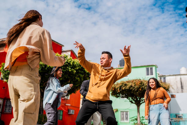 istock Young man dancing with friends outdoors 2201761150