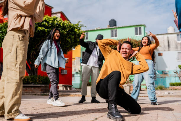 istock Young man dancing with friends outdoors 2201761235