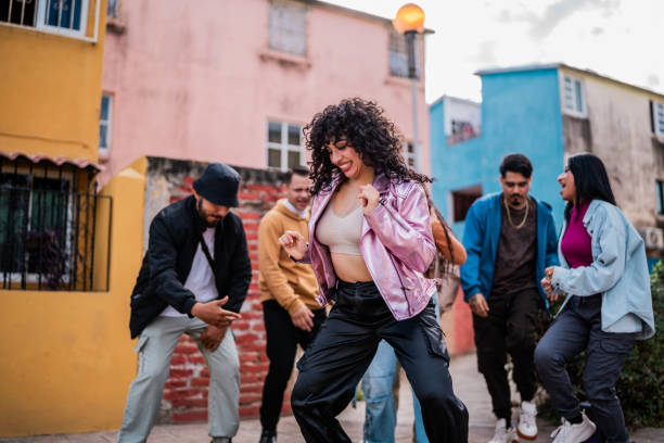 istock Young woman dancing with friends outdoors - Point of view 2201762110