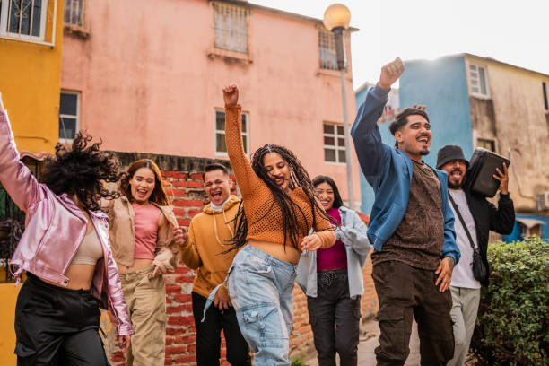 istock Young friends walking and dancing outdoors 2201762118