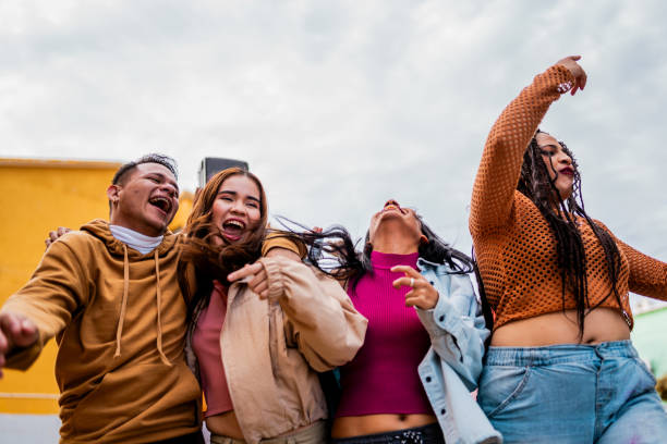istock Young friends walking and dancing outdoors 2201762219