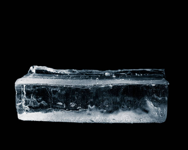 istock Ice tray on a black background. Block of textured ice. 2201762500