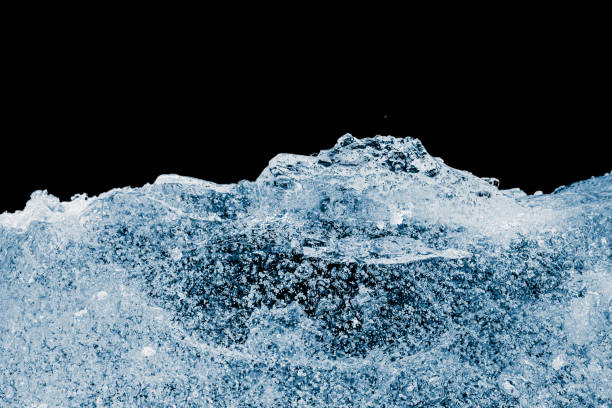 istock Pure textured crushed ice piece with air bubbles on a black background. 2201762621