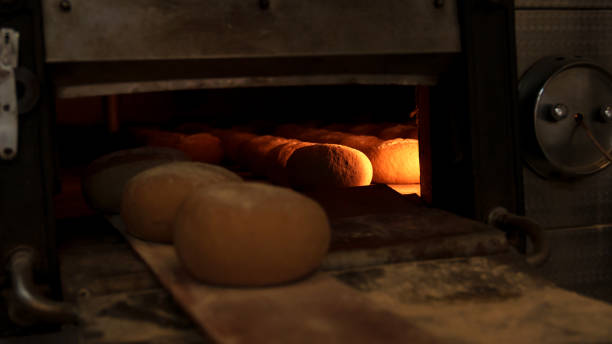 istock Freshly baked bread loaves inside an industrial oven 2201762655