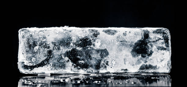 istock Natural textured ice block, covered with rime crystal structure, isolated on a black background with reflection. 2201764221