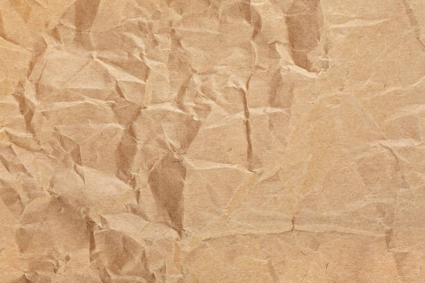 istock Crumpled packaging brown paper textured background. Vintage brown paper. 2201769467