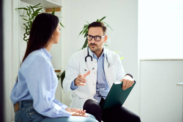 istock Doctor Consulting With Patient During a Health Checkup in a Bright Office 2201770368