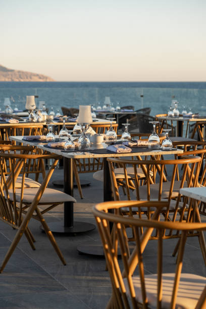 istock Dreamy sunset dining by the ocean, featuring beautifully set tables and an ambia 2201780927