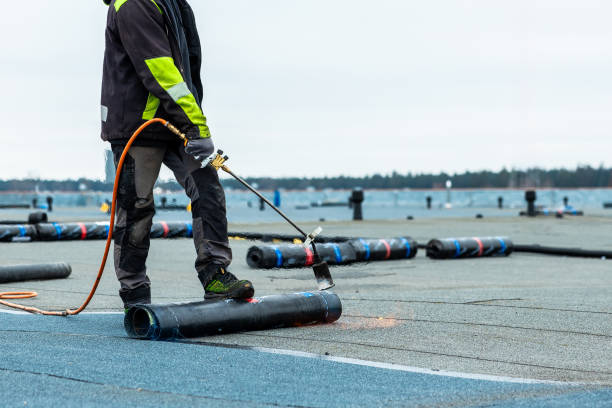 istock Worker Applies Torch On Roofing Material on Flat Rooftop Near Waterfront 2201781994