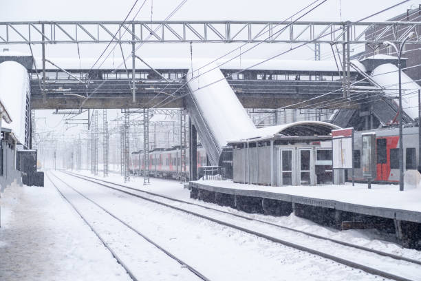 istock Snow covered railway station with snowstorm effects during winter morning hours 2201782635