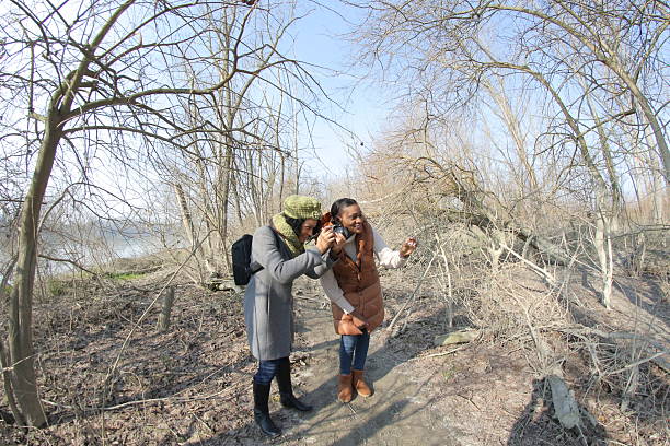 istock Two photographers taking pictures in a forest during winter 2201784875