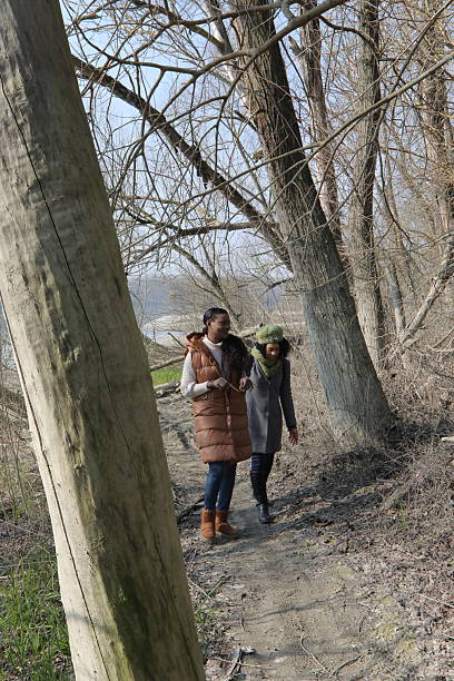 istock Two friends walking and talking in a park during early spring 2201784997
