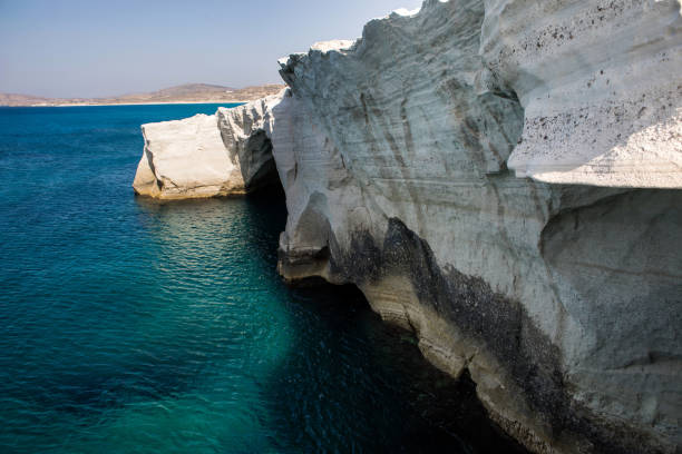 White cliffs towering over the mediterranean sea at Sarakiniko Beach on the island of Milos in the Greek Islands