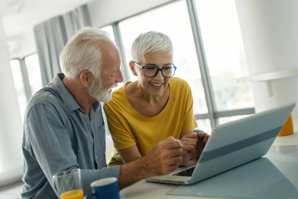 istock Mature couple using laptop at home 2201789406