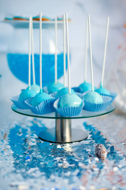 istock Blue cake pops on the silver cloth. Sea time theme on the party's candy bar 2201791008