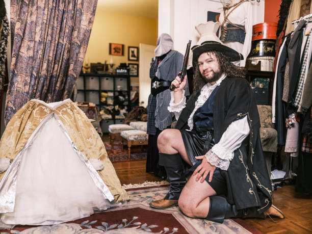 Young gay actor dressed in period costume inside design studio. Interior of creative studio at home in Hamilton, Canada.