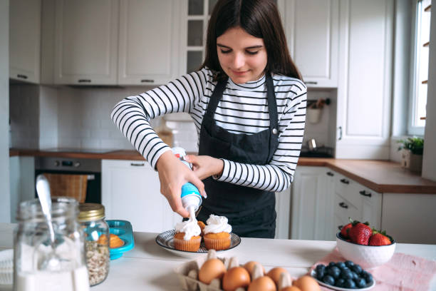 istock Piping Cream on Freshly Baked Cupcakes 2201794510