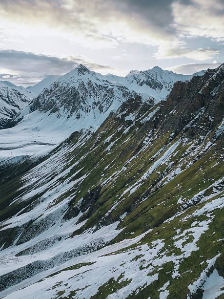 istock high relief mountains covered with snow, mountain range, aerial view drone shot 2201795130