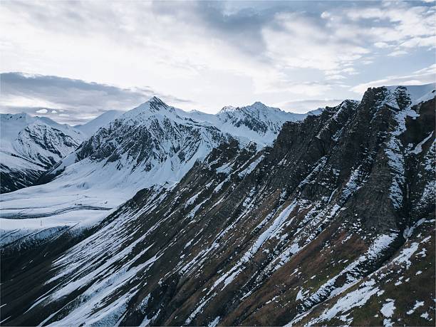 high relief mountains covered with snow, mountain range, aerial view drone shot