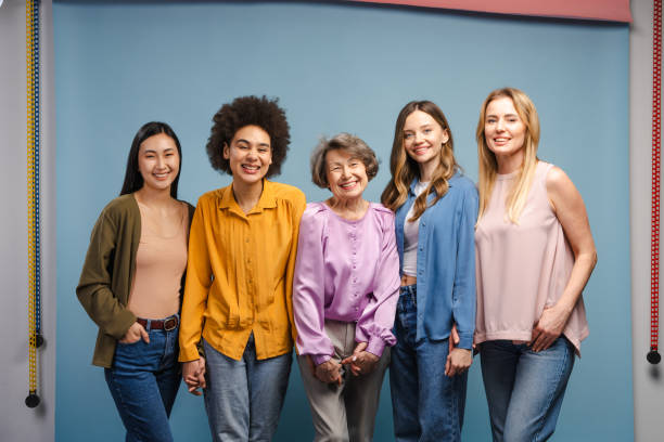istock Five women of different ages and ethnicities smiling together 2201797454