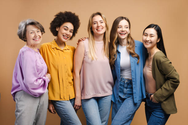 istock Five cheerful multi-ethnic women of different ages bonding and laughing together 2201797456