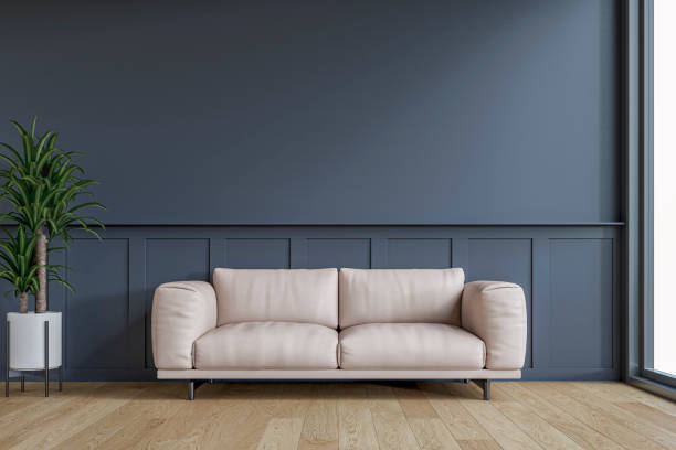istock Modern interior: a living room with a cream leather sofa, half dark blue wainscoting and half dark blue plaster wall background and decoration 2201799341