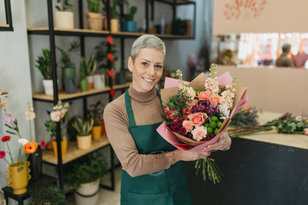 istock Florist showcasing a vibrant floral arrangement 2201799569