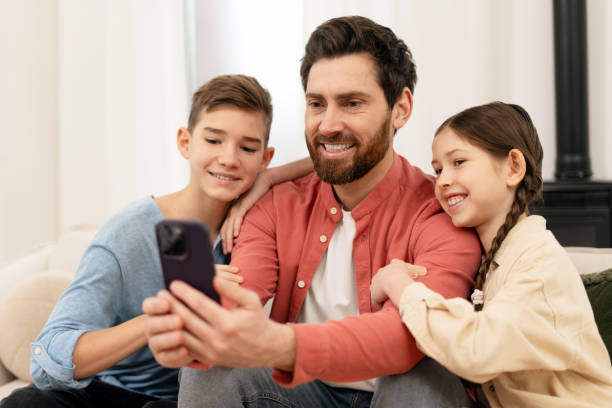 istock Happy family taking selfie with smartphone at home 2201801668
