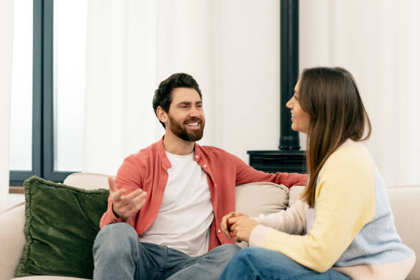 istock Happy couple enjoying a relaxing conversation at home 2201801737