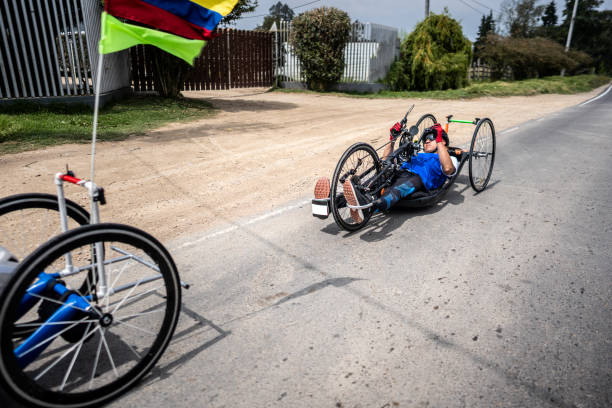 Athlete with disabilities riding a handcycle on a city street