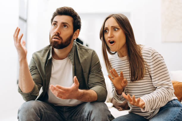 istock Young couple arguing and gesturing with hands at home 2201802194