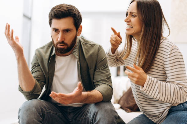 istock Young couple arguing vehemently at home on sofa 2201802198