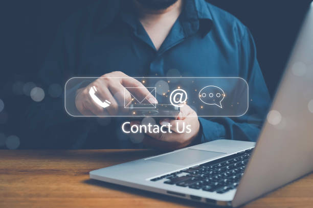 istock Concept of contact us, customer support, service, icon, Contact us or Customer support hotline people connect. Businessman using a laptop with the (email, call phone, mail) icons. customer service. 2201802248