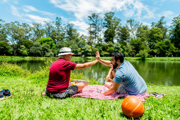 Father and son doing high five in a public park