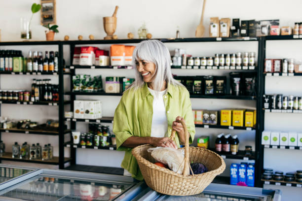 istock Senior woman choosing mindful consumption in organic store 2201805605