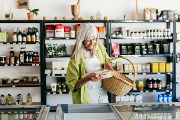 istock Senior woman choosing mindful consumption in organic store 2201805619