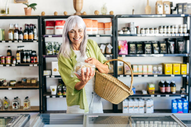 istock Senior woman choosing mindful consumption in organic store 2201805640