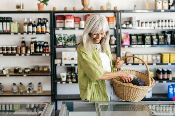 istock Senior woman choosing mindful consumption in organic store 2201805663